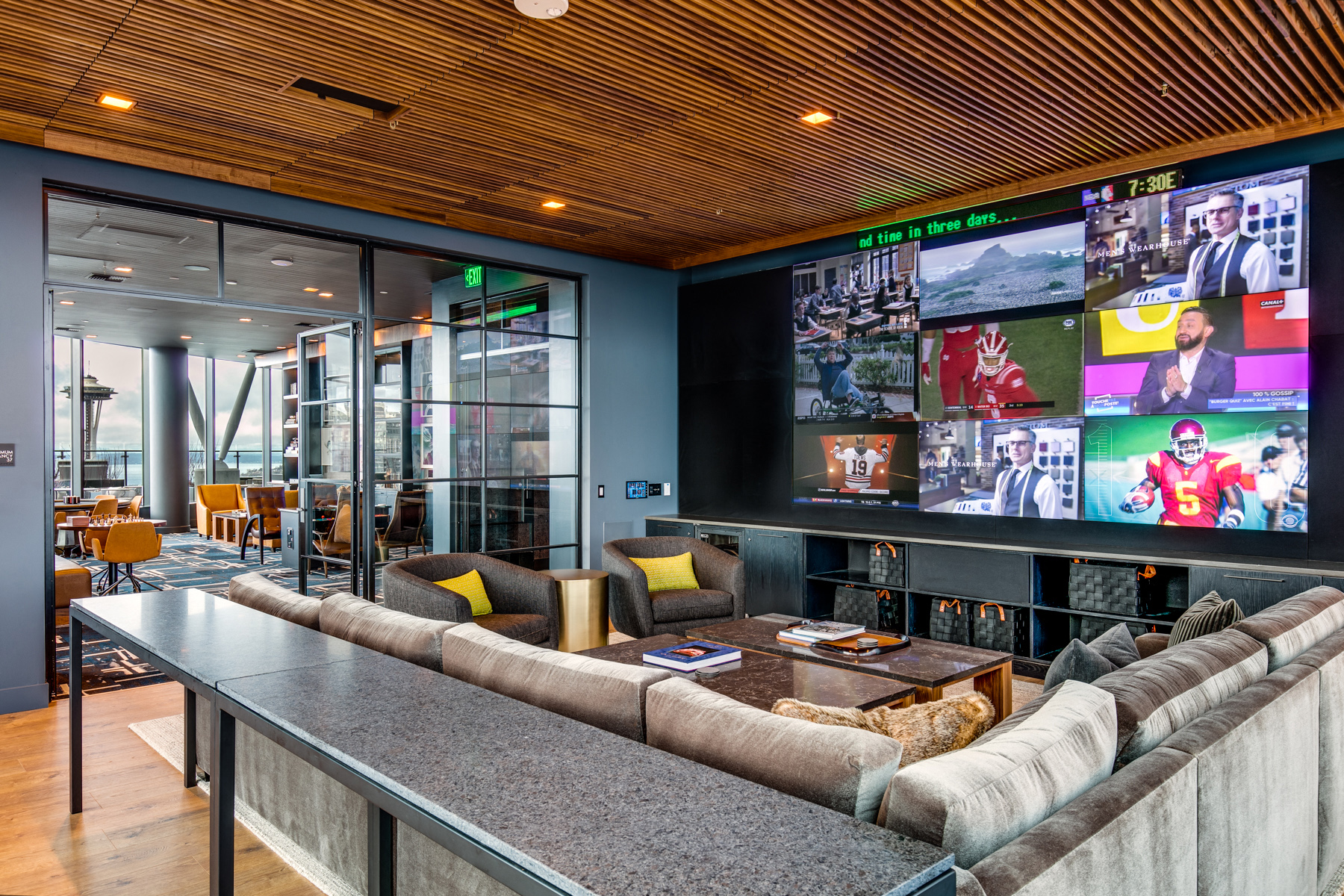 a living room with couches and a large screen tv